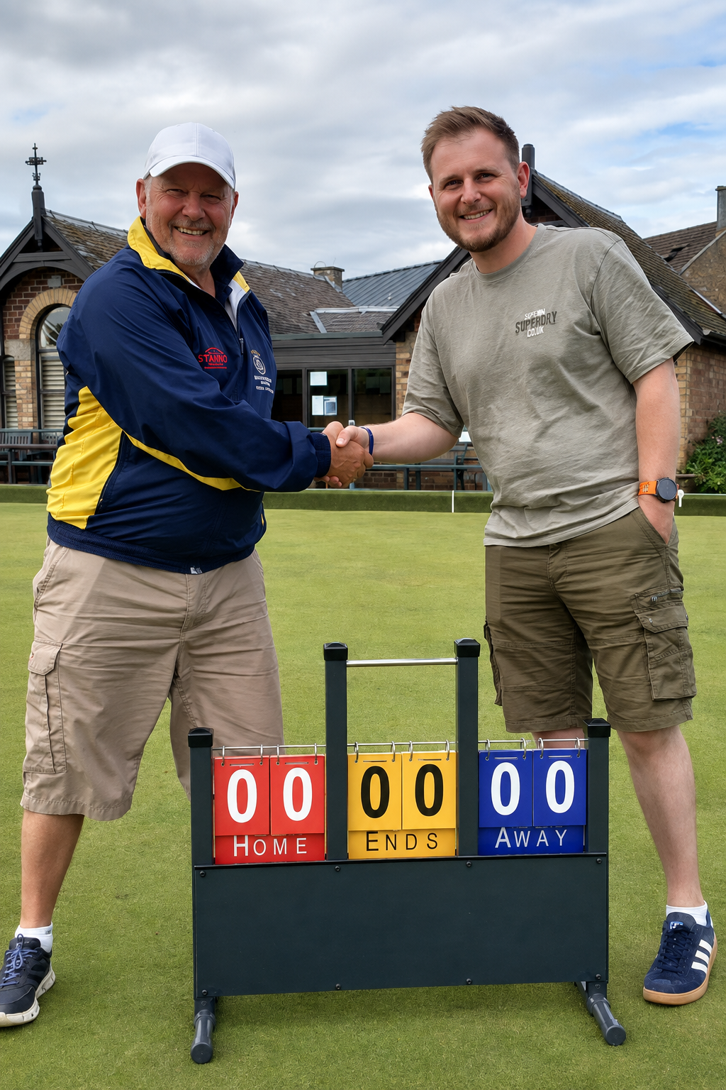 Chris Spry shaking hands with a club member beside a BowlScoreboard bowls scoreboard on the green