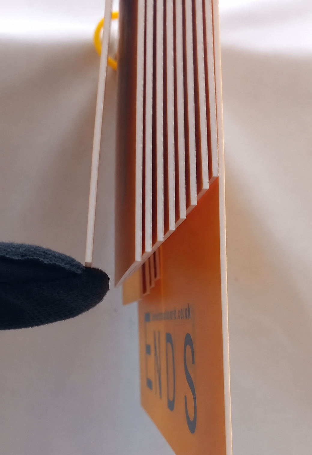 Close-up of a gloved finger sliding under one number, the remaining numbers hanging cleanly above