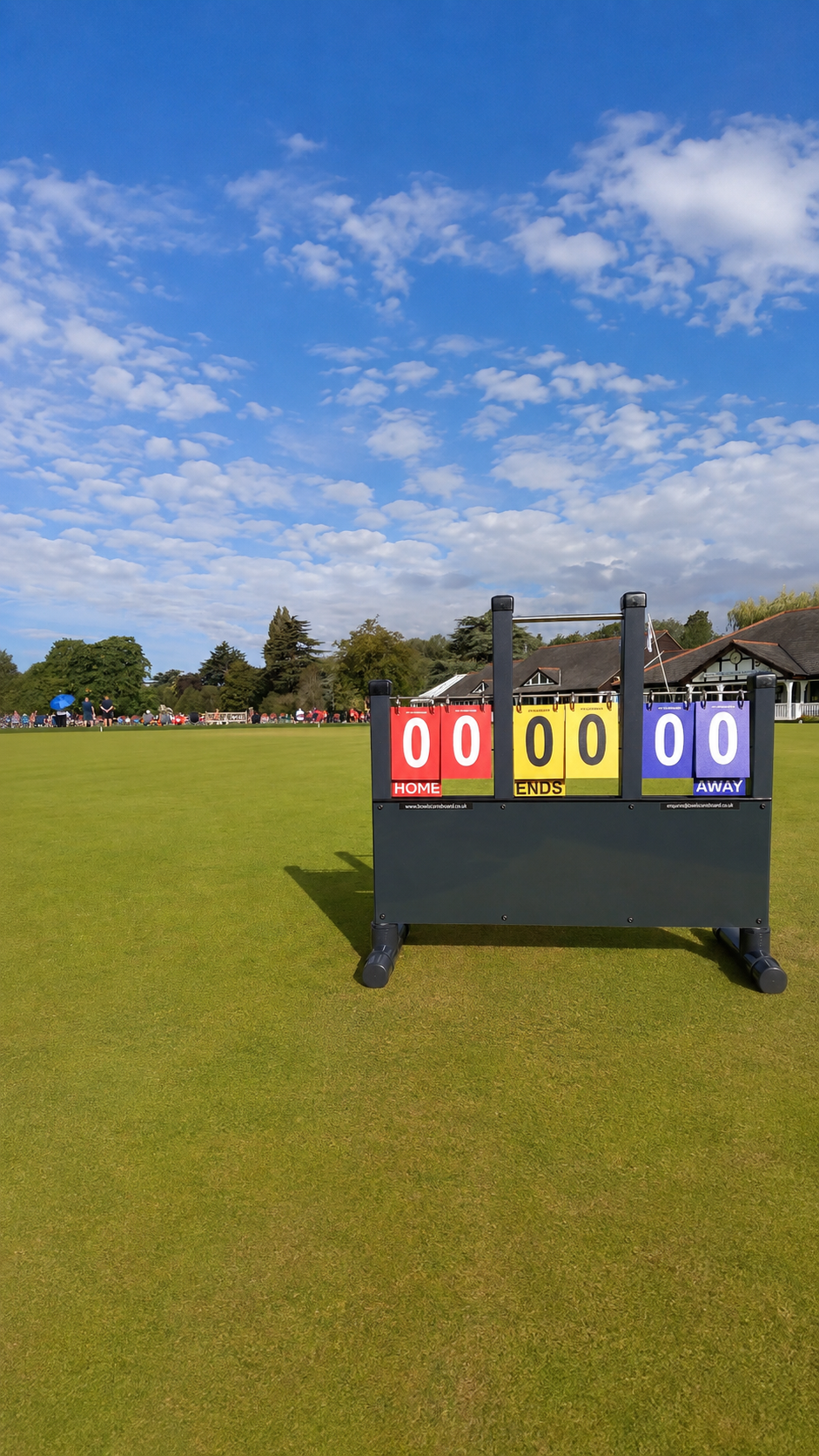 A BowlScoreboard picked-number bowls scoreboard standing beside a lawn bowls green